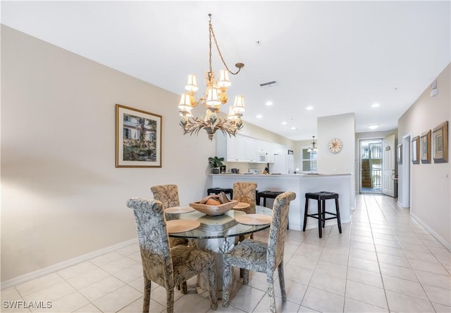 dining area featuring light tile patterned floors, baseboards, visible vents, and a chandelier