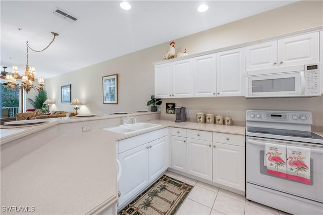 kitchen with light tile patterned floors, light countertops, visible vents, a sink, and white appliances