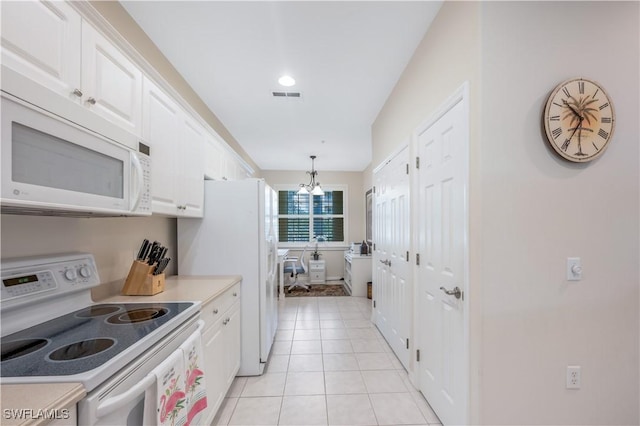 kitchen with light tile patterned floors, white appliances, white cabinetry, light countertops, and an inviting chandelier