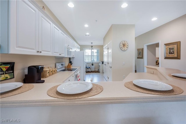 bathroom with a chandelier and recessed lighting