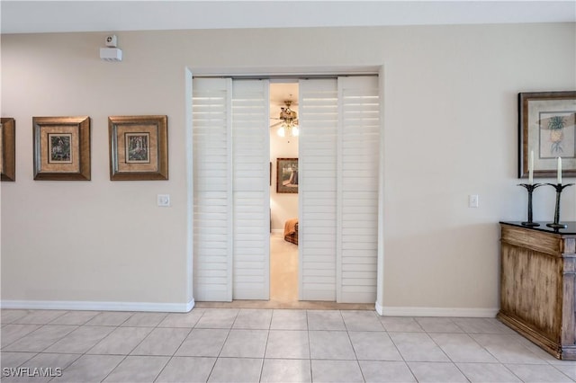 interior space with light tile patterned floors and baseboards