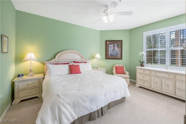 bedroom featuring baseboards, a ceiling fan, and light colored carpet