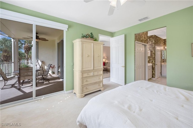 bedroom with visible vents, light colored carpet, ceiling fan, ensuite bathroom, and access to exterior