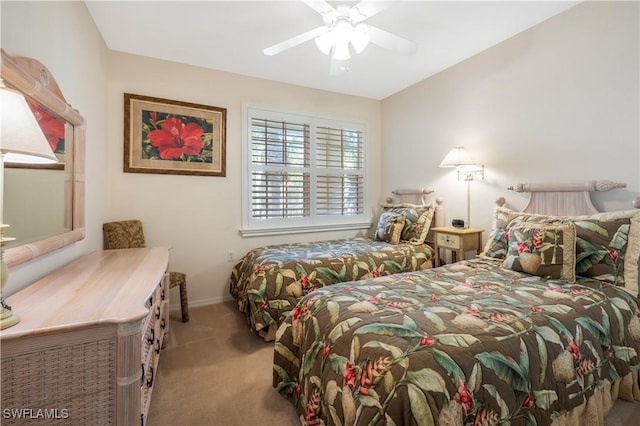 carpeted bedroom featuring ceiling fan and baseboards