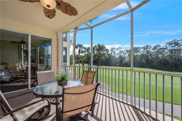 sunroom featuring a ceiling fan