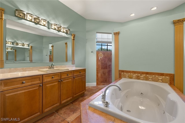 bathroom with vanity, tile patterned floors, and tiled bath