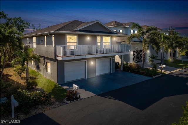 view of front of home featuring a garage and a balcony