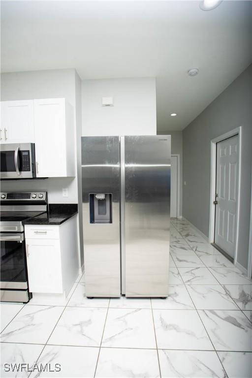 kitchen featuring white cabinets and appliances with stainless steel finishes