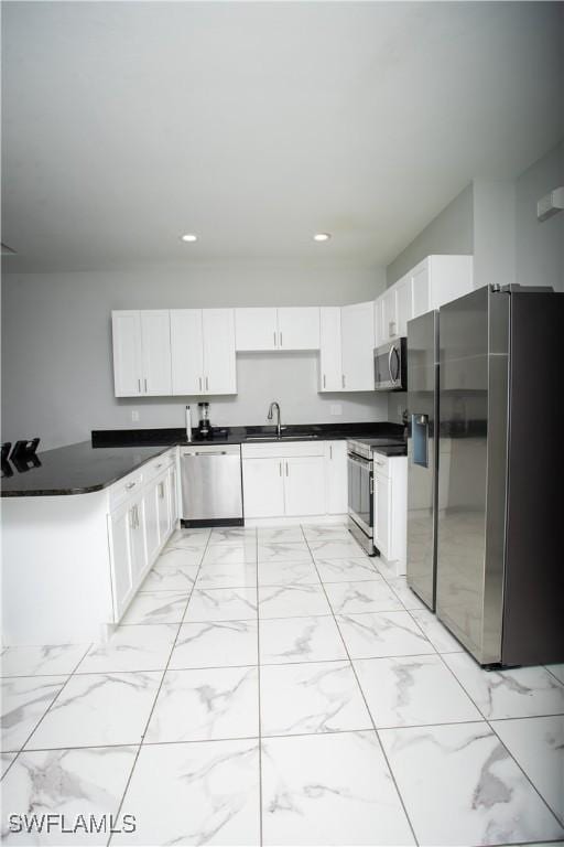 kitchen featuring white cabinetry, appliances with stainless steel finishes, and sink