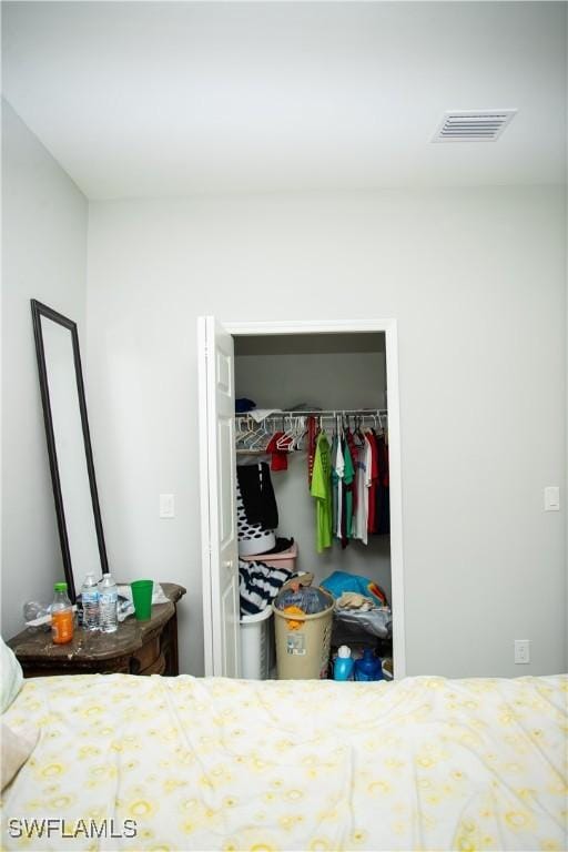 bedroom featuring a spacious closet and a closet