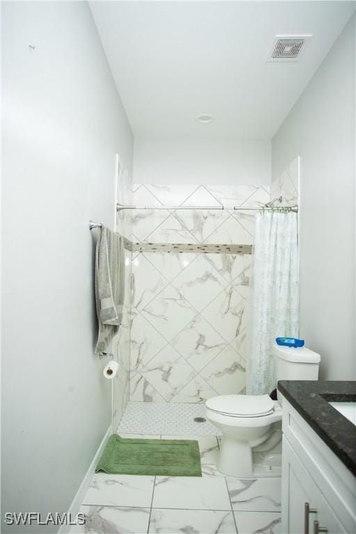 bathroom featuring vanity, curtained shower, and toilet