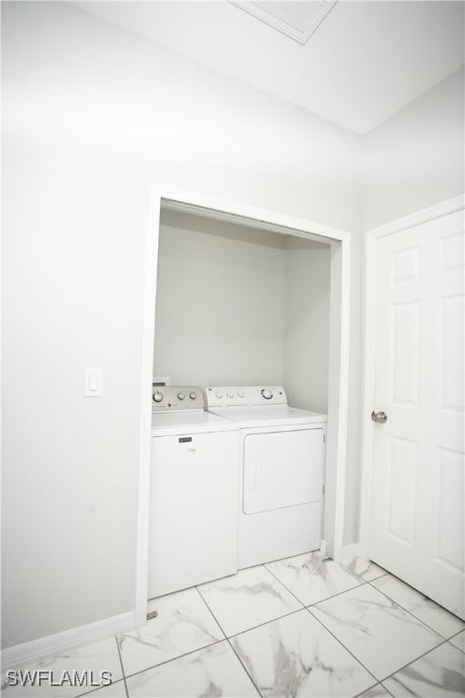 laundry room with washing machine and dryer
