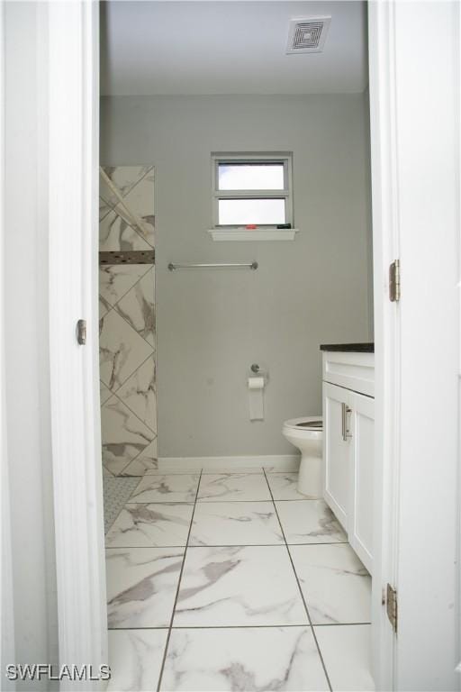 bathroom featuring vanity and toilet