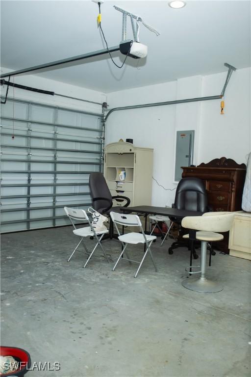 garage featuring a garage door opener and electric panel