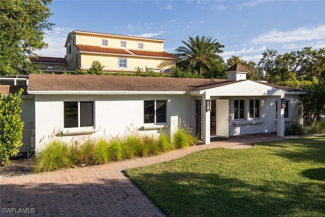 rear view of property featuring a yard