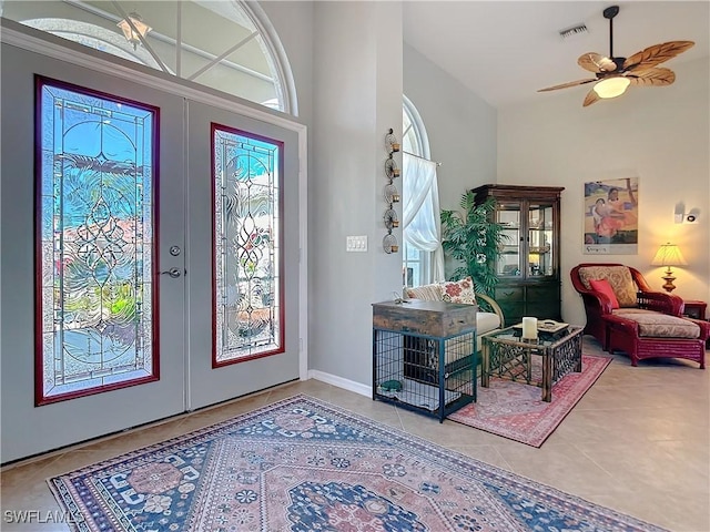 20790 Athenian Ln, North Fort Myers, FL 33917 - tiled foyer featuring a ceiling fan, french doors, visible vents, and a high ceiling