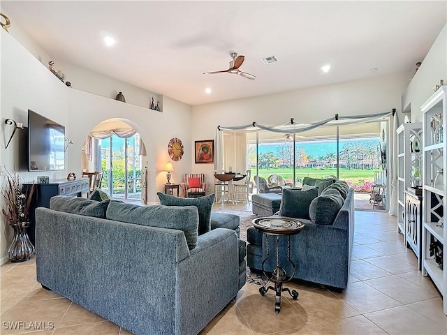 tiled living room featuring ceiling fan