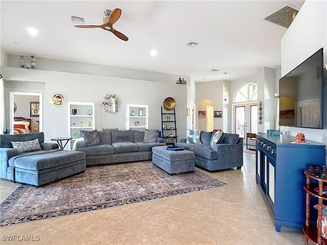 living room with light tile patterned floors and ceiling fan