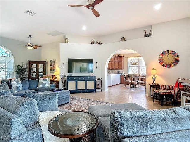 tiled living room featuring ceiling fan