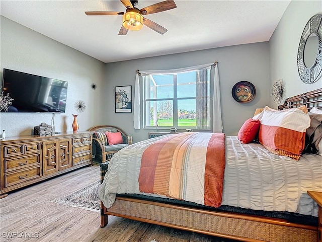 bedroom with ceiling fan and wood-type flooring