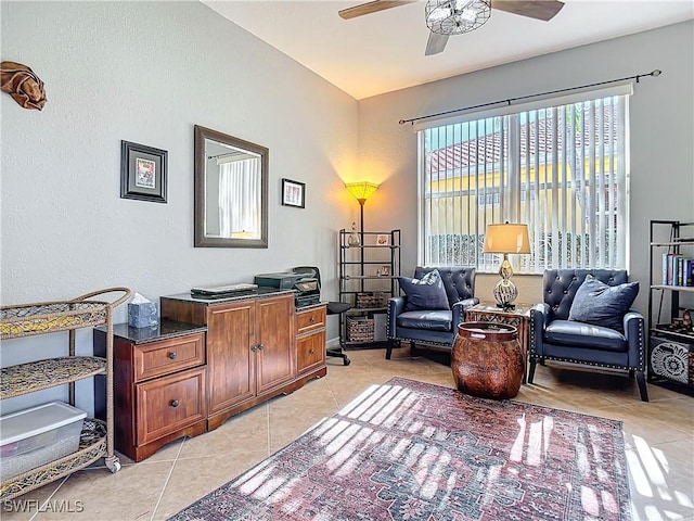 interior space featuring light tile patterned flooring and ceiling fan