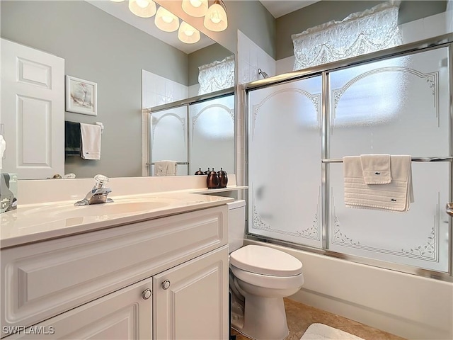 full bathroom with shower / bath combination with glass door, vanity, and toilet