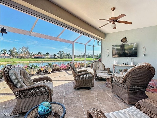 view of patio / terrace featuring a water view, ceiling fan, and glass enclosure