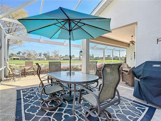 view of patio / terrace featuring a lanai, ceiling fan, and grilling area