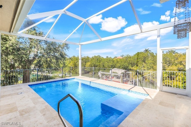 view of pool featuring a lanai and a patio