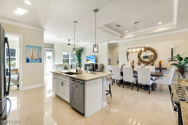 kitchen with pendant lighting, white cabinetry, sink, light stone counters, and stainless steel appliances