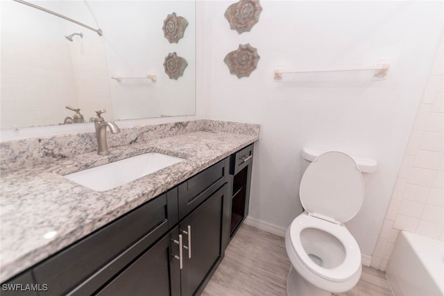 full bathroom with washtub / shower combination, vanity, toilet, and wood-type flooring