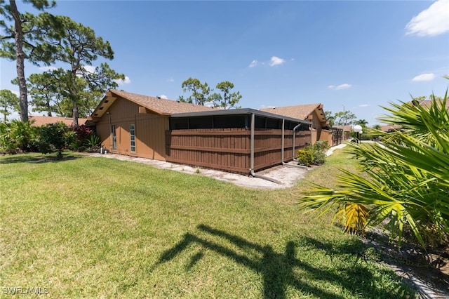 rear view of property featuring a yard