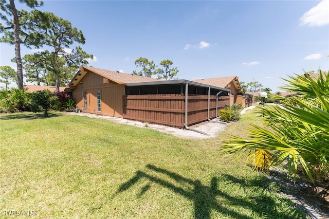 back of property featuring a lawn