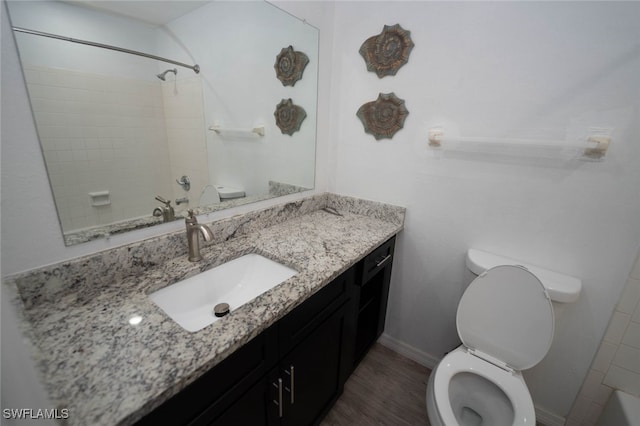 bathroom with hardwood / wood-style flooring, vanity, and toilet