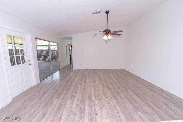 unfurnished living room featuring ceiling fan and light wood-type flooring