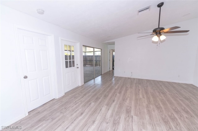 empty room with lofted ceiling, light hardwood / wood-style floors, and ceiling fan