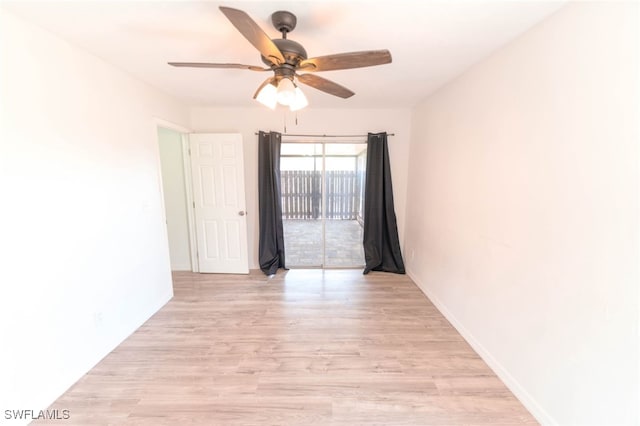 spare room with ceiling fan and light wood-type flooring