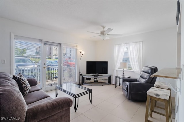 tiled living room featuring ceiling fan