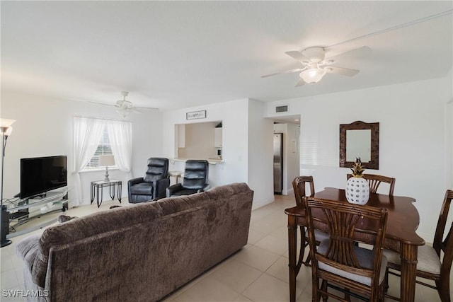 living room featuring light tile patterned floors and ceiling fan