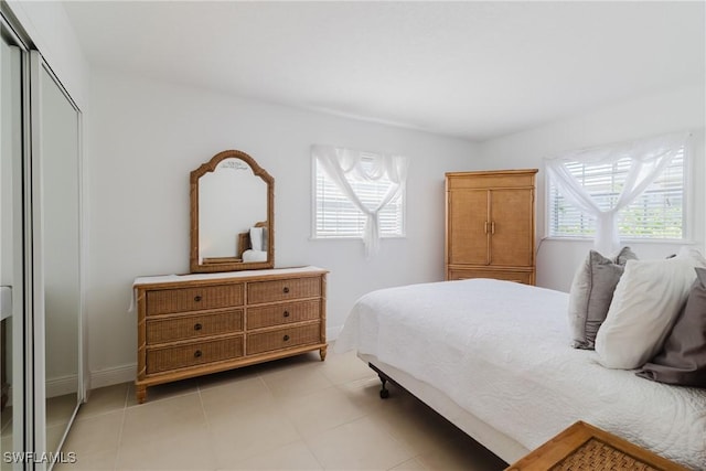 bedroom featuring a closet and light tile patterned floors