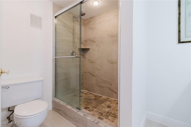 bathroom with toilet, tile patterned flooring, and a shower with door