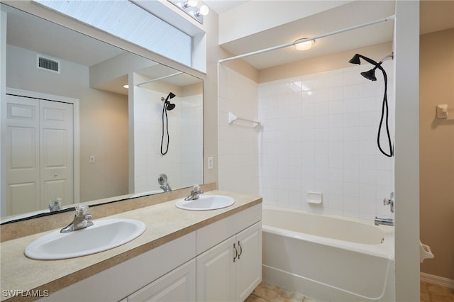 bathroom with double vanity, tile patterned flooring, a sink, and washtub / shower combination