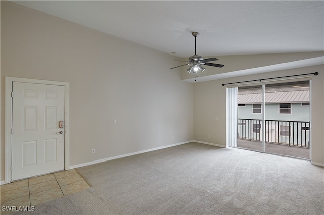 tiled empty room featuring carpet, baseboards, vaulted ceiling, and a ceiling fan