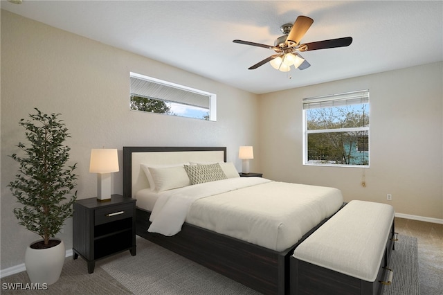 bedroom with ceiling fan, carpet floors, and baseboards