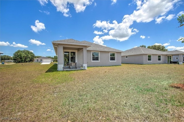 rear view of house featuring a yard