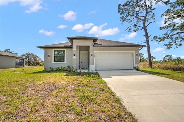 prairie-style home with a garage, driveway, a front lawn, and stucco siding