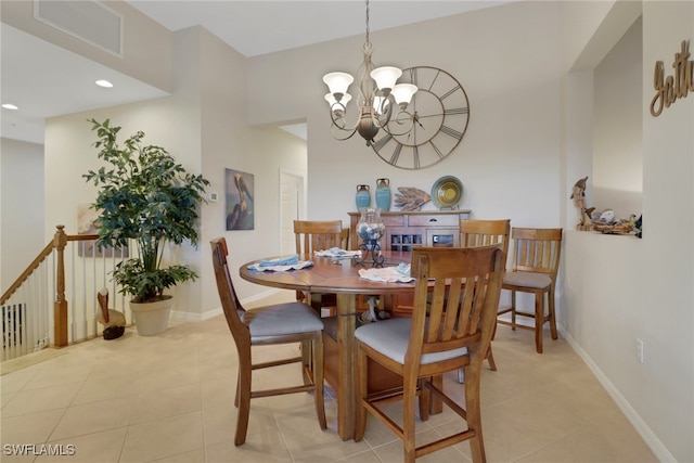 dining room featuring light tile patterned flooring and a notable chandelier