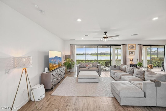 living area featuring visible vents, recessed lighting, and wood finished floors