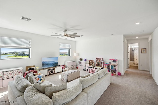 living room with a ceiling fan, baseboards, visible vents, recessed lighting, and light carpet