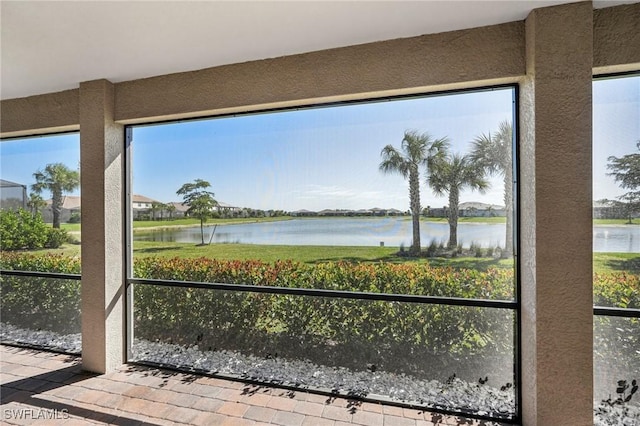 unfurnished sunroom with a water view